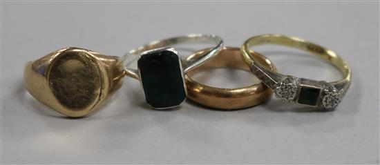 A sapphire and diamond three stone ring, two gold bands and another ring.